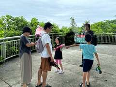 图一 台湾猕猴共存推广协会在园区外热点劝导游客收好物品，降低人猴冲突。